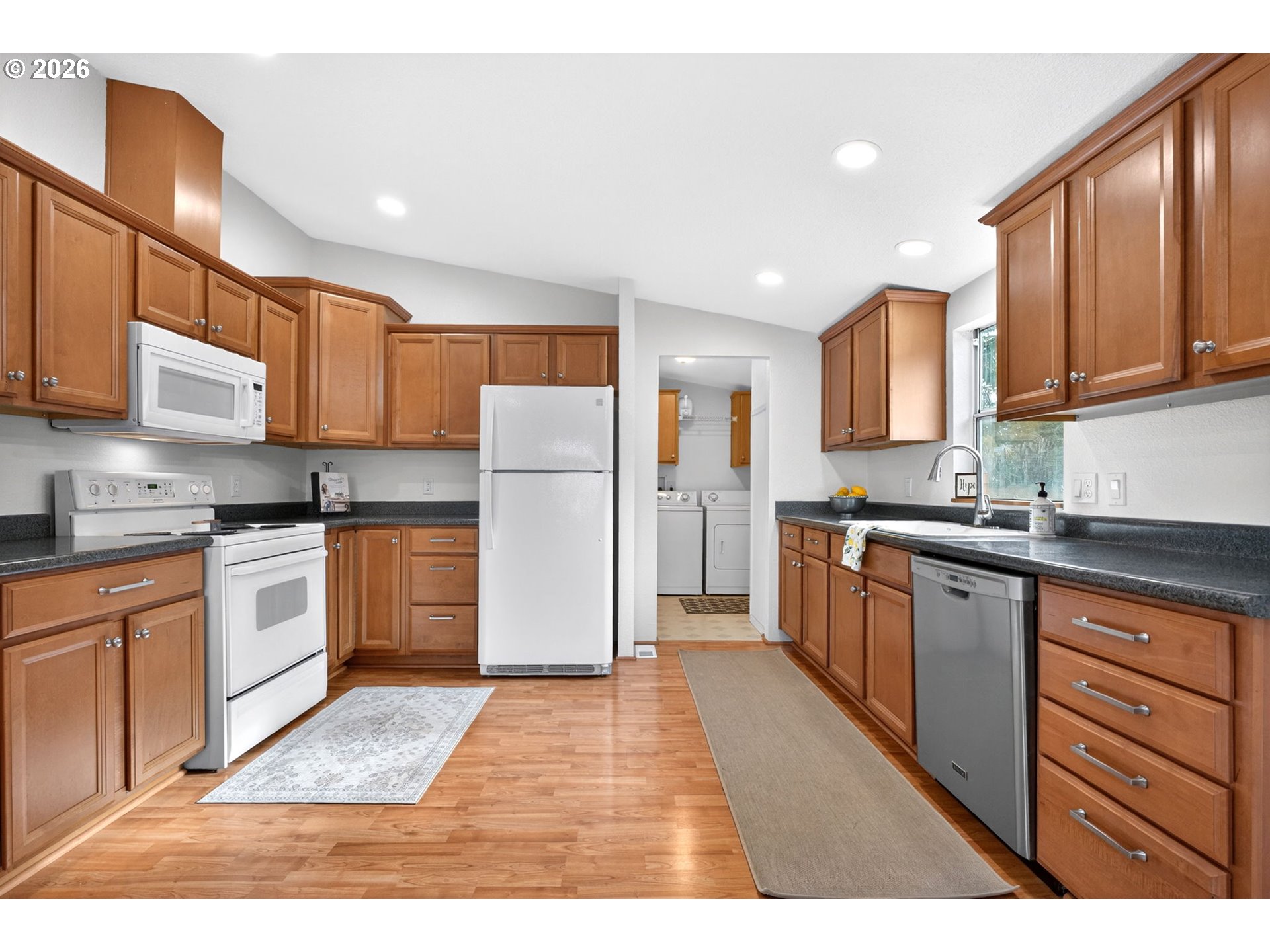110 South Harrison Street Newberg, OR 97132 - Photo 10 of 41 a kitchen with a refrigerator sink and cabinets
