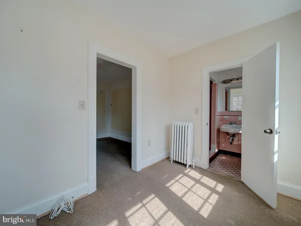 a view of an empty room and bedroom