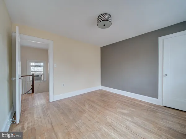 a view of hallway with wooden floor