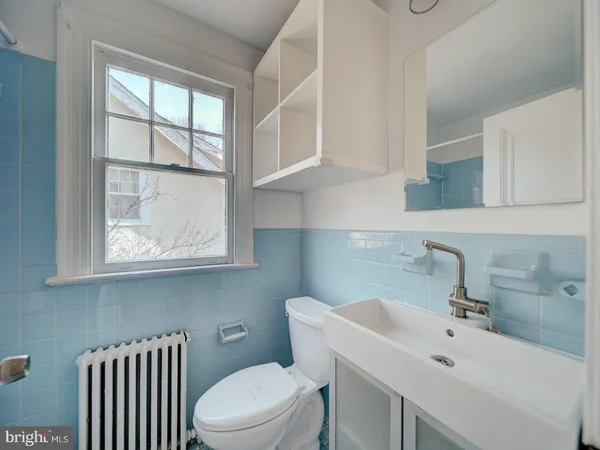 a bathroom with a sink a toilet and vanity
