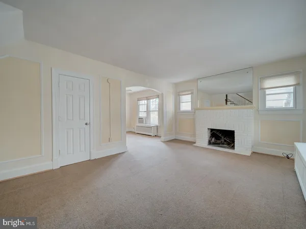 a view of a livingroom with a fireplace and window