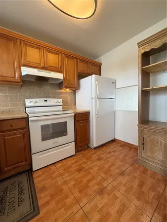 a kitchen with a stove and a refrigerator