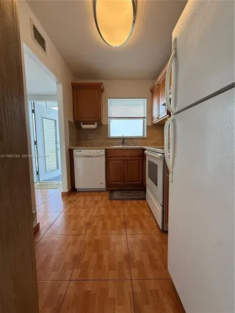 a kitchen with a sink cabinets and stainless steel appliances