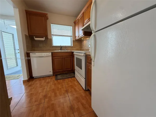 a kitchen with a sink cabinets and stainless steel appliances