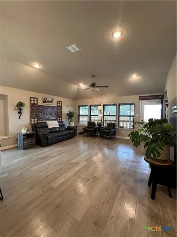 a living room with lots of furniture and a chandelier