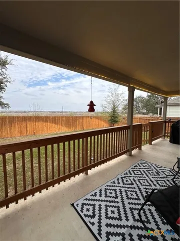 a balcony with wooden floor in outdoor space