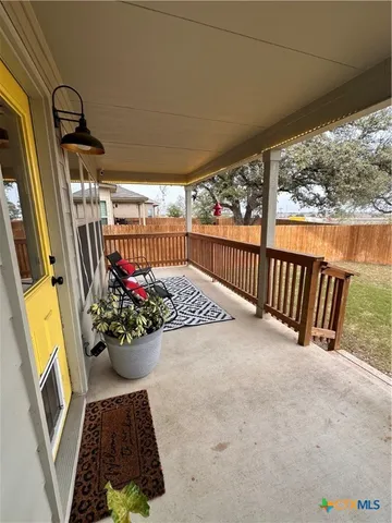 a view of a balcony with furniture