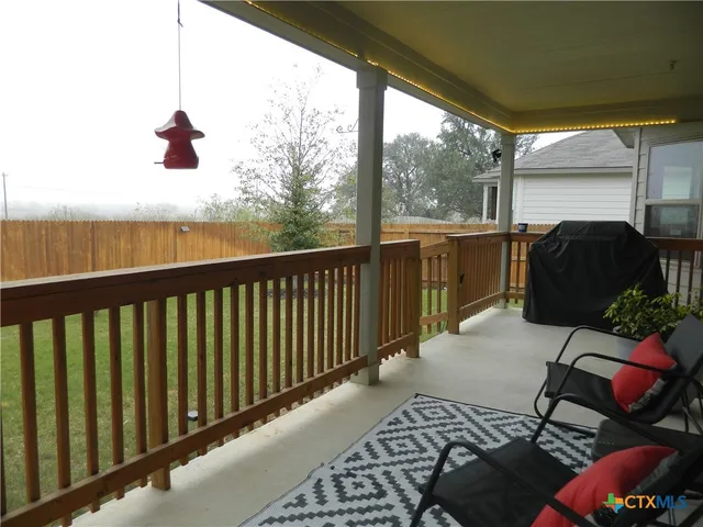 a view of balcony with furniture