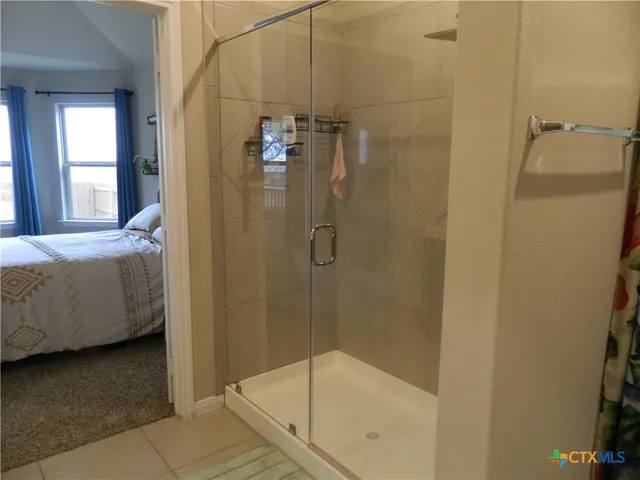 a bathroom with a glass shower door