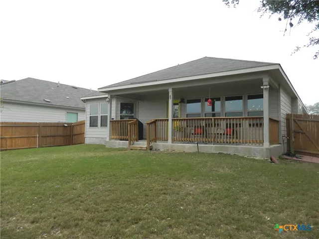 a view of a house with a yard and deck