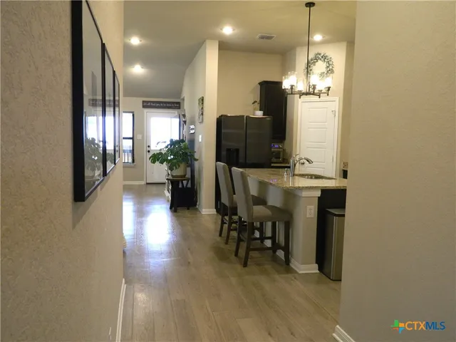 a view of a livingroom with furniture and a flat screen tv