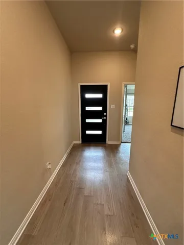 a view of room with wooden floor