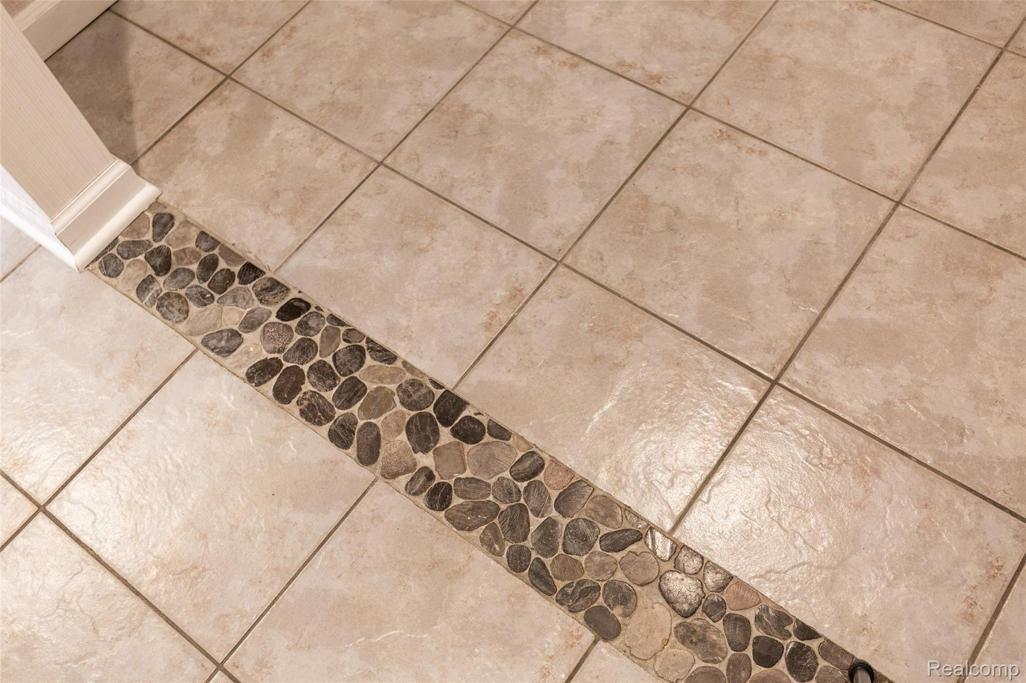 7784 Tipsico Lake Road Holly, MI 48442 - Photo 19 of 55 Sparkling ceramic tile flooring with stone detail