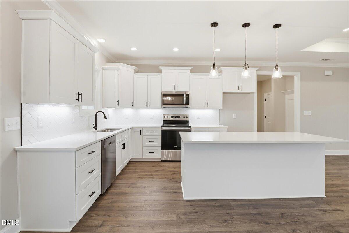 1381 Scarlet Oak Rd Spring Spring Hope, NC 27882 - Photo 12 of 23 a large kitchen with stainless steel appliances and white cabinets