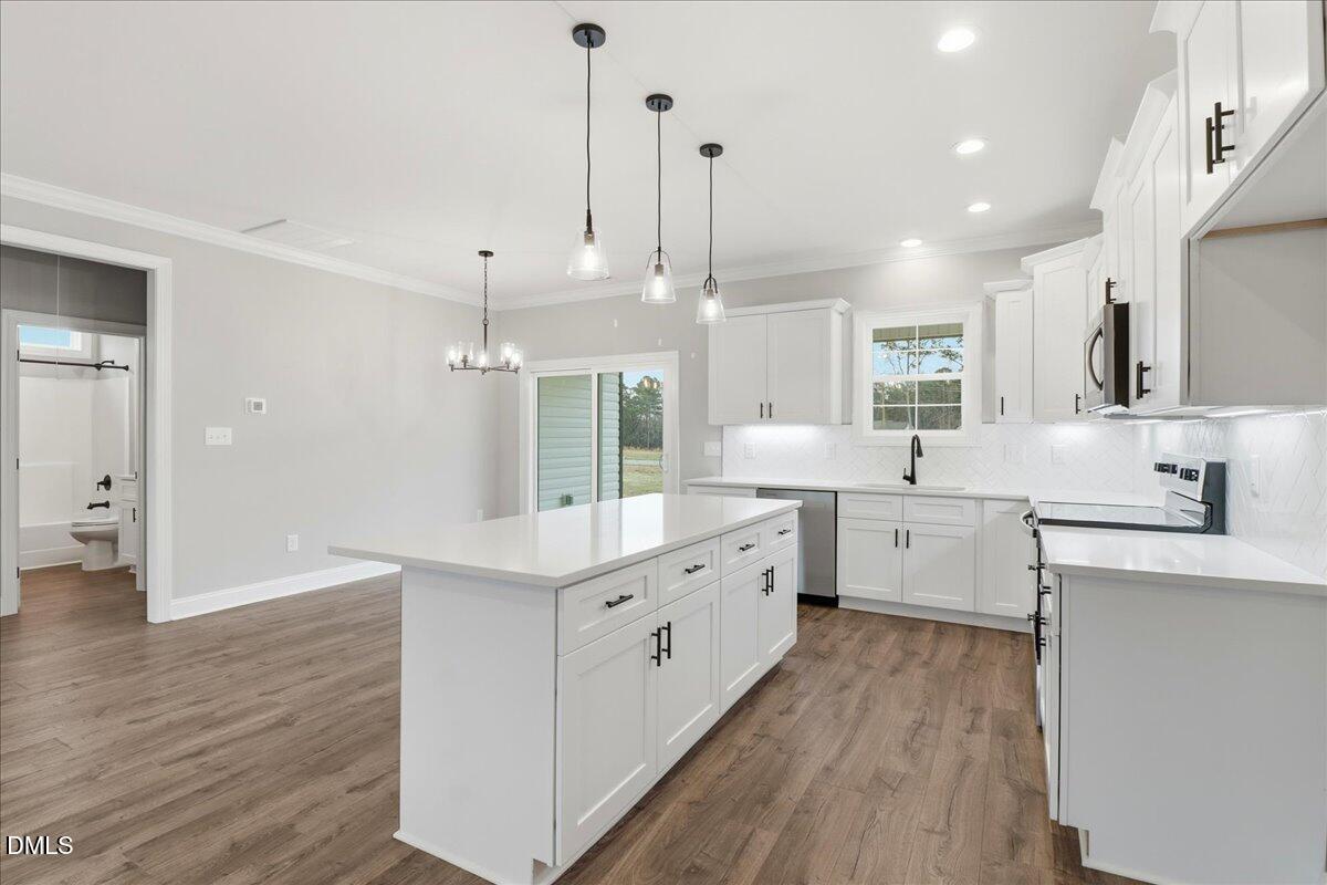 1381 Scarlet Oak Rd Spring Spring Hope, NC 27882 - Photo 10 of 23 a large white kitchen with a large window a sink stainless steel appliances and cabinets