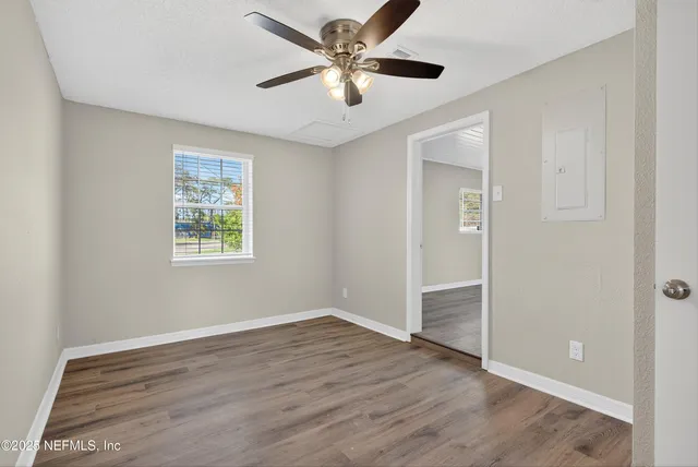 wooden floor in an empty room with a window