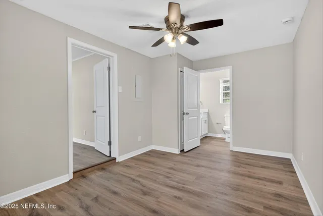 a view of an empty room with wooden floor