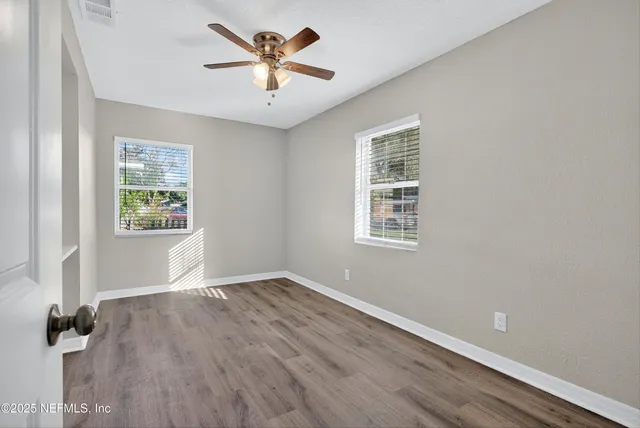 wooden floor in an empty room with a window