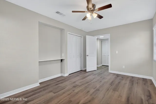 wooden floor in an empty room with a window
