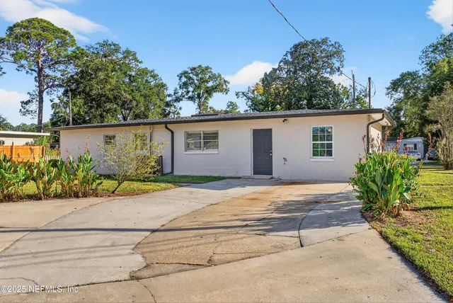 front view of house with potted plants