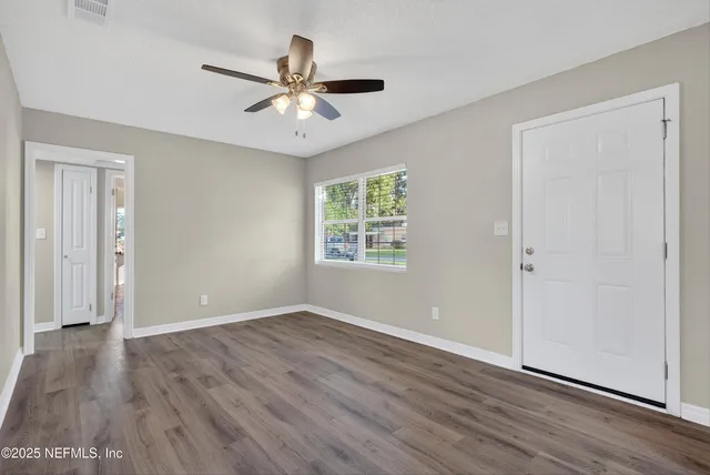 wooden floor in an empty room with a window
