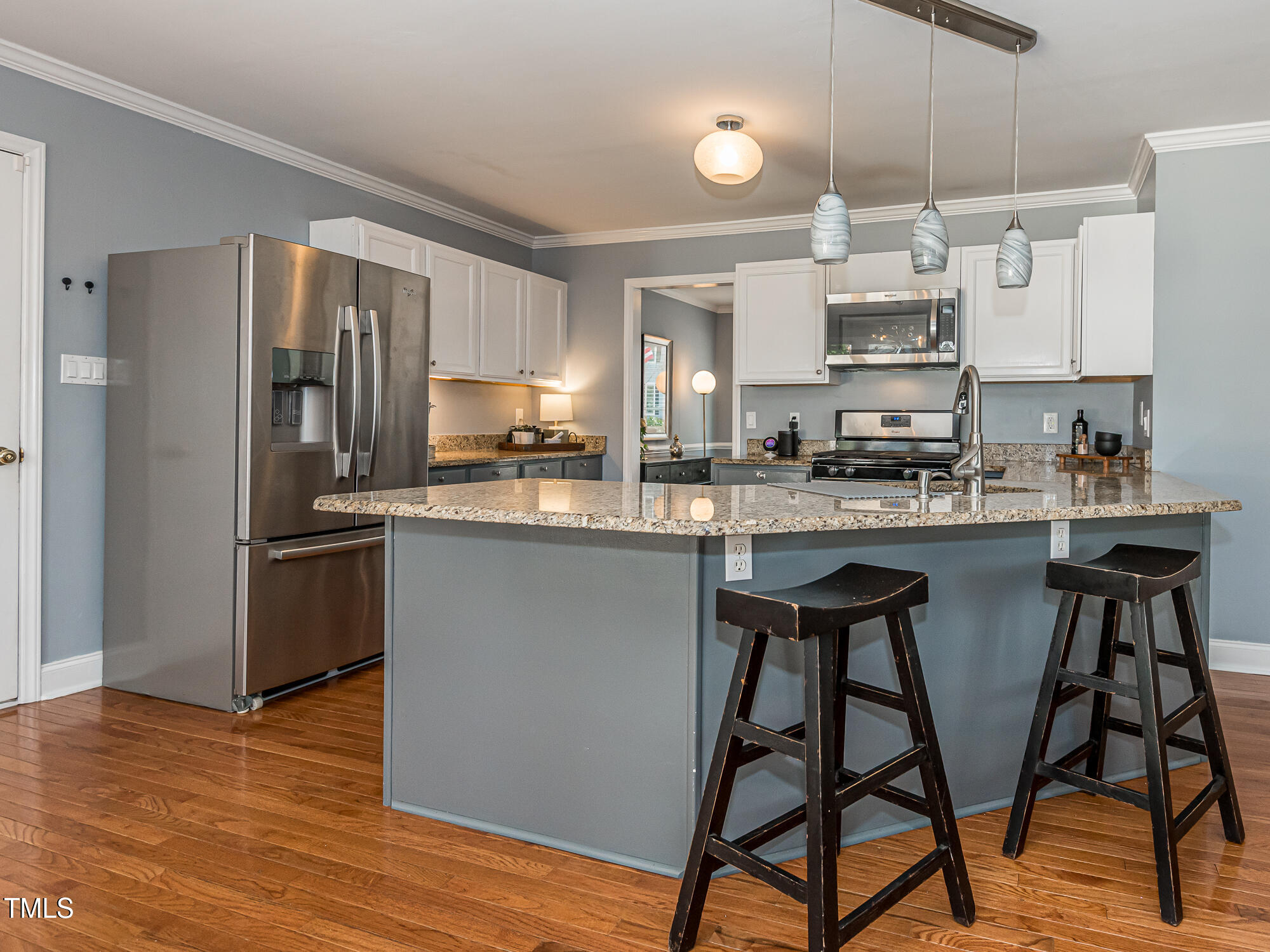 4617 Atterbury Court Raleigh, NC 27604 - Photo 11 of 41 a kitchen with stainless steel appliances a microwave a stove a sink dishwasher a refrigerator and cabinets with wooden floor