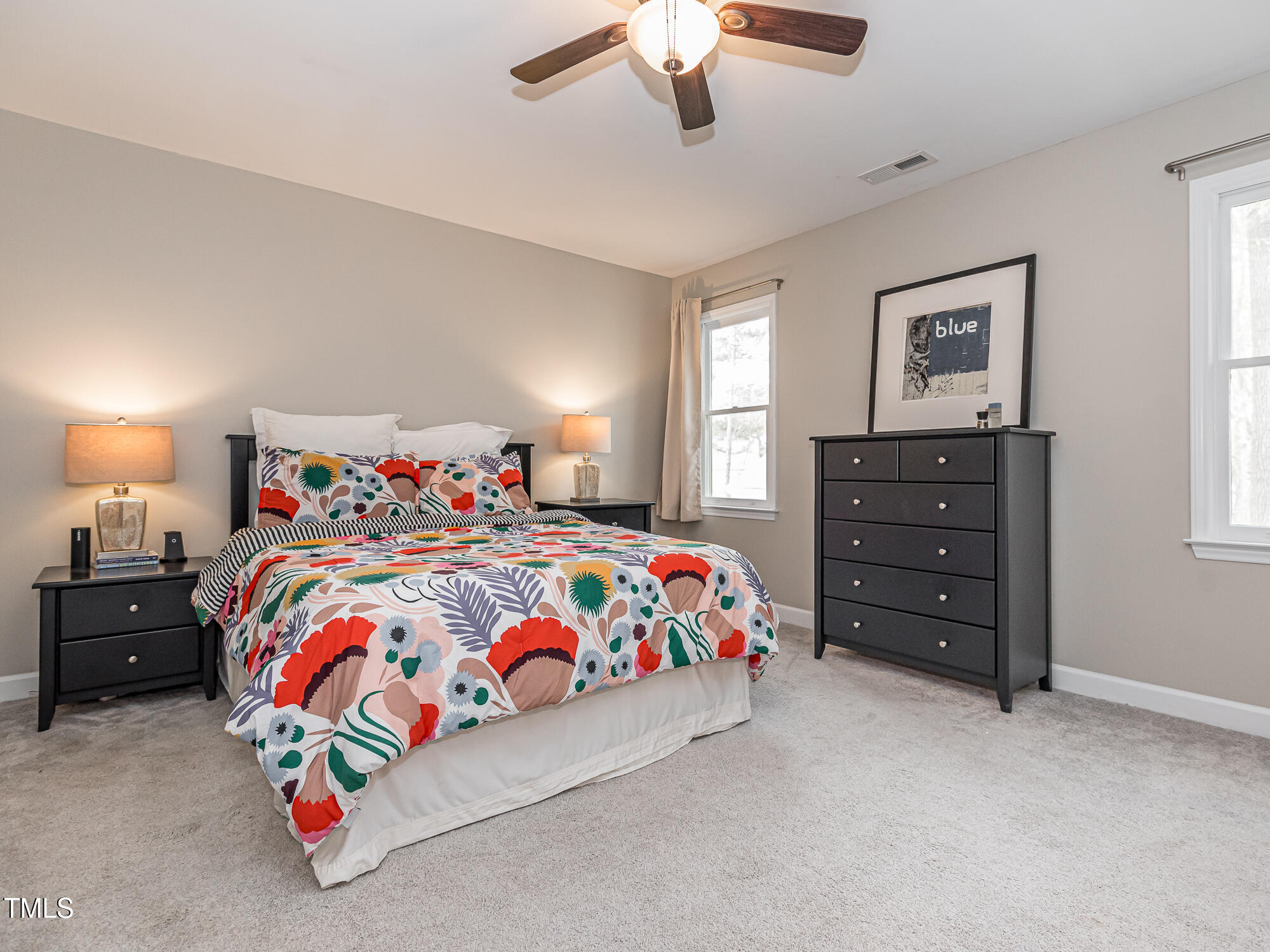 4617 Atterbury Court Raleigh, NC 27604 - Photo 18 of 41 a bedroom with a bed and a lamp on dresser