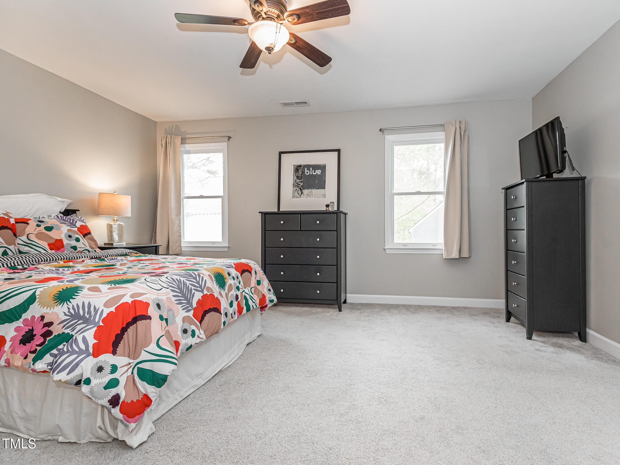 4617 Atterbury Court Raleigh, NC 27604 - Photo 19 of 41 a bedroom with a bed and wooden floor