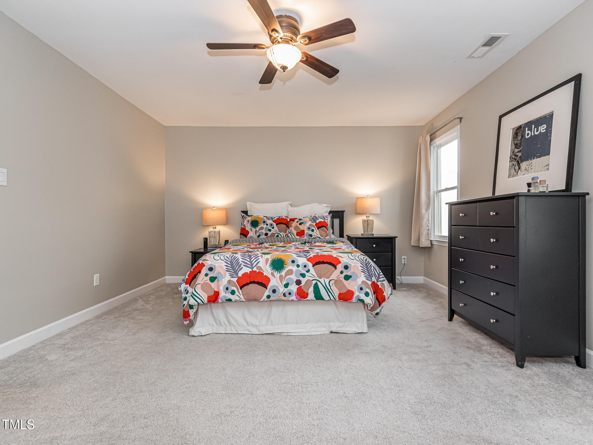 4617 Atterbury Court Raleigh, NC 27604 - Photo 20 of 41 a bedroom with a bed and a chandelier