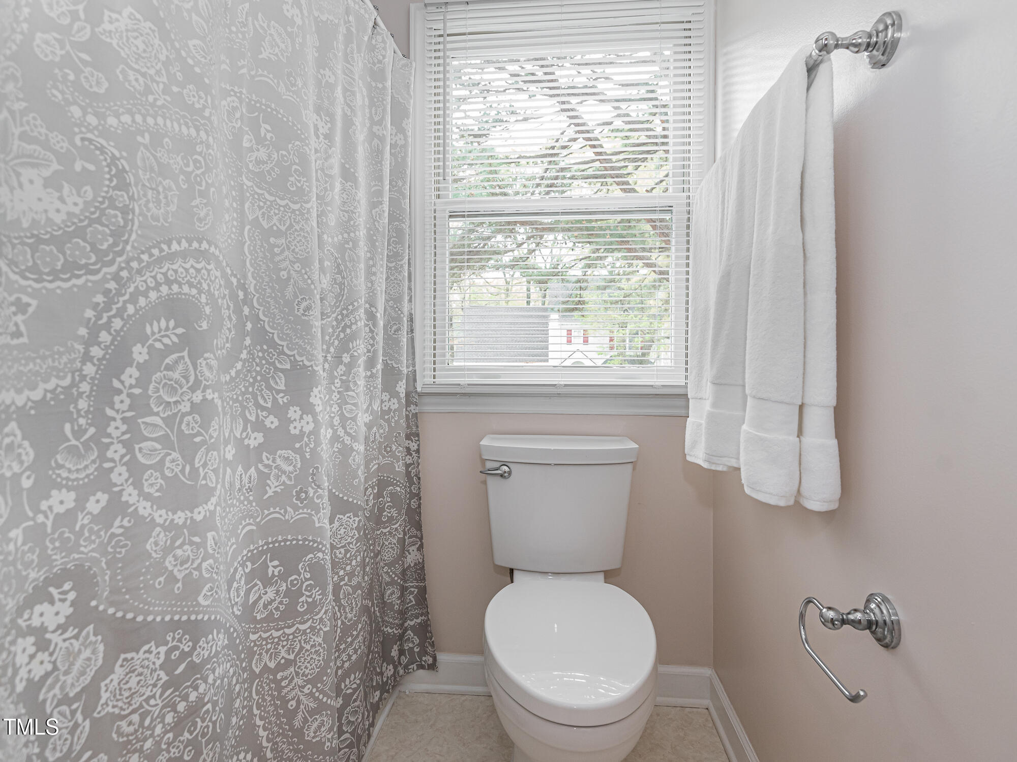 4617 Atterbury Court Raleigh, NC 27604 - Photo 29 of 41 a white toilet sitting next to a window and a shower