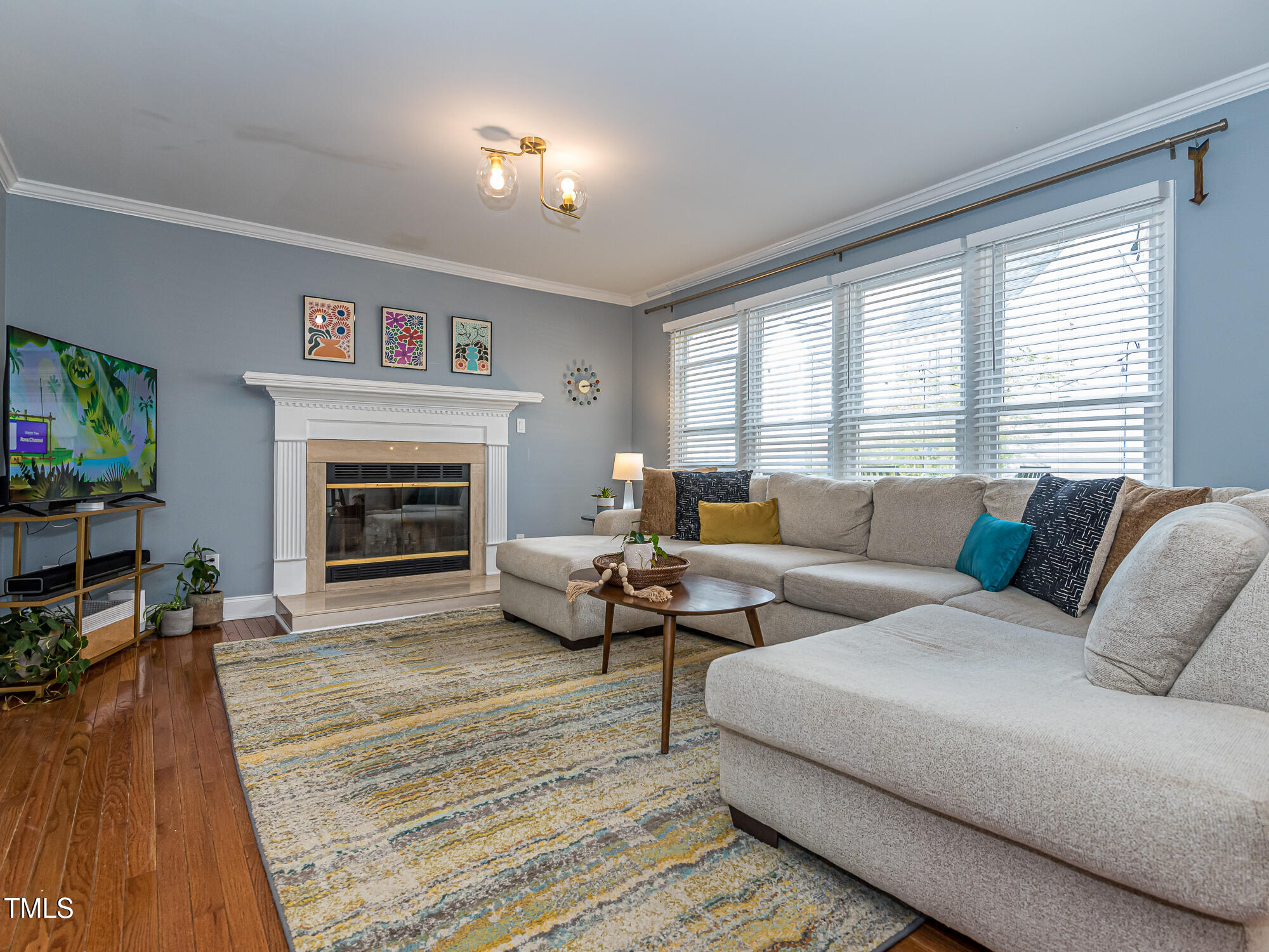 4617 Atterbury Court Raleigh, NC 27604 - Photo 8 of 41 a living room with furniture a large window and a fireplace