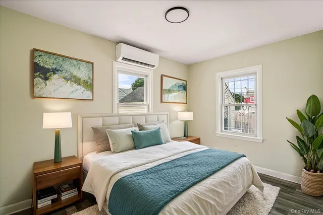 a bedroom with a bed and a painting on the wall