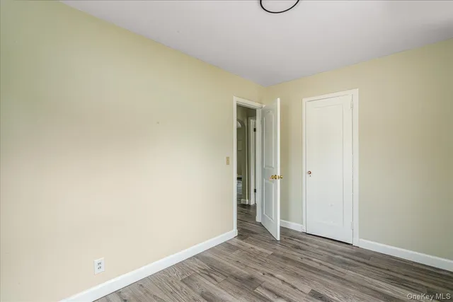 a view of an empty room and wooden floor