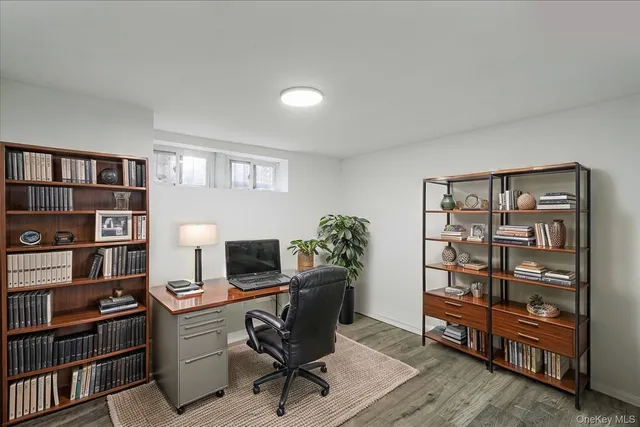 a view of a workspace with furniture and book shelf