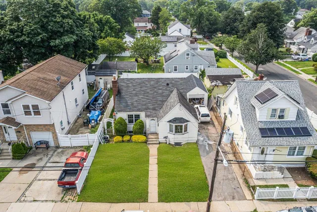 a aerial view of multiple houses with yard