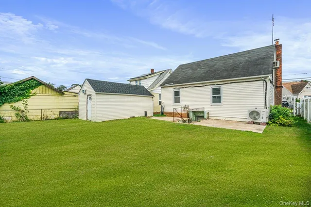 a front view of house with yard and outdoor seating