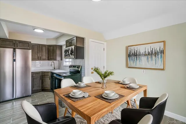 a view of a dining room with furniture a kitchen and chandelier
