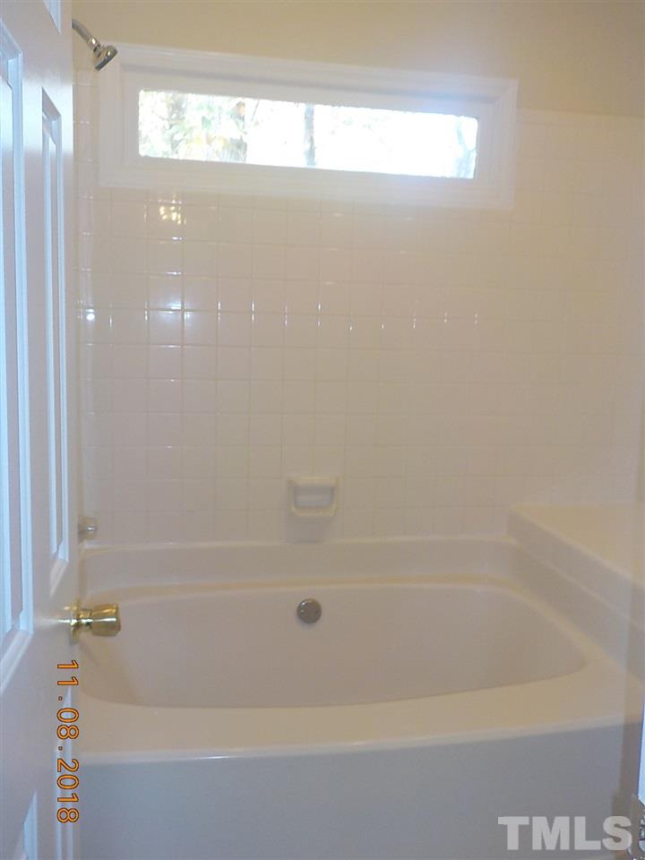 3317 Singleleaf Lane Raleigh, NC 27616 - Photo 11 of 19 a close up of a bathtub in a bathroom