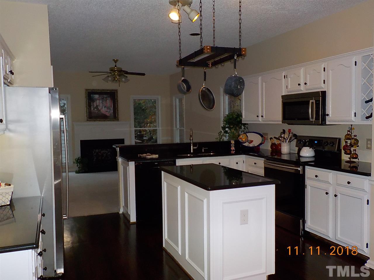 3317 Singleleaf Lane Raleigh, NC 27616 - Photo 5 of 19 a kitchen with a sink stove and microwave