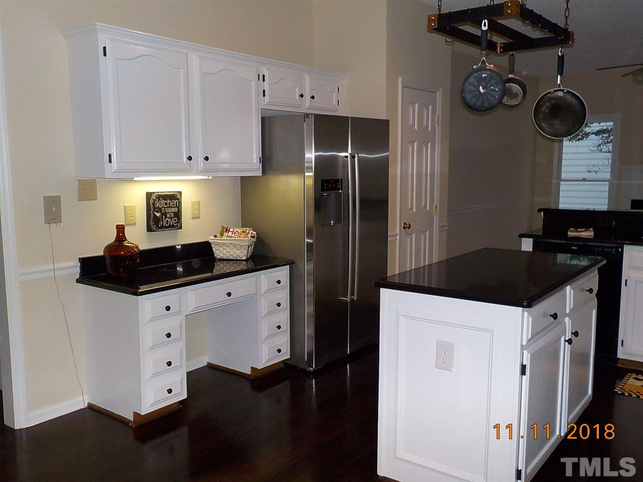 3317 Singleleaf Lane Raleigh, NC 27616 - Photo 6 of 19 a kitchen with granite countertop white cabinets and refrigerator