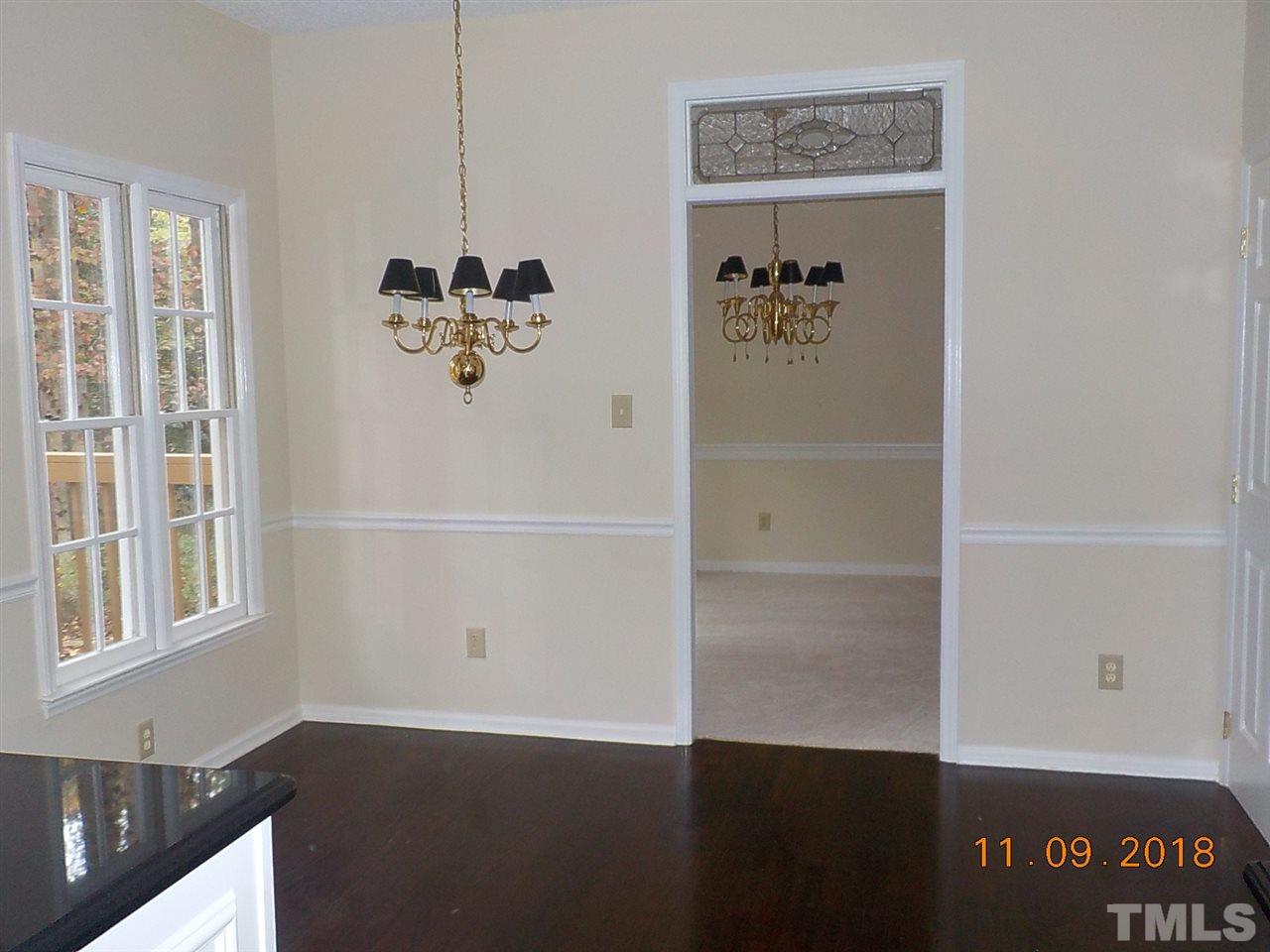 3317 Singleleaf Lane Raleigh, NC 27616 - Photo 7 of 19 an empty room with wooden floor and windows