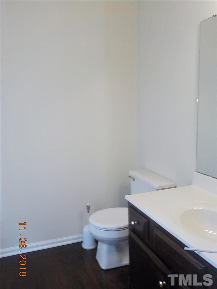 3317 Singleleaf Lane Raleigh, NC 27616 - Photo 8 of 19 a bathroom with a sink a toilet and a vanity