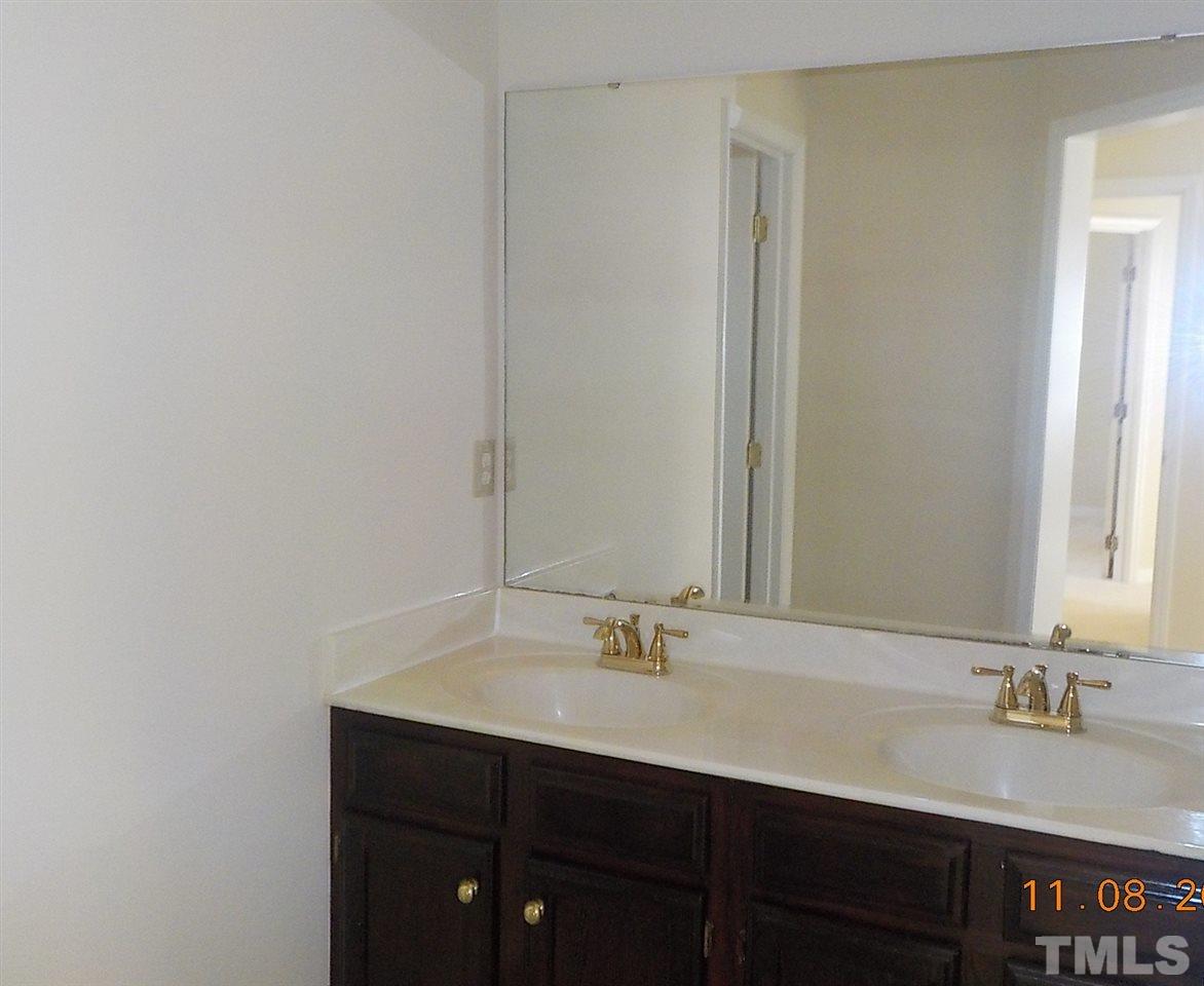 3317 Singleleaf Lane Raleigh, NC 27616 - Photo 10 of 19 a bathroom with a sink and a mirror