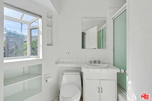 a bathroom with a sink toilet vanity and tub