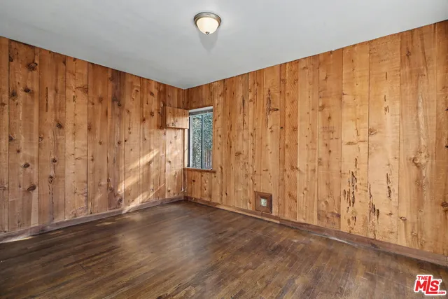 a view of an empty room and wooden floor