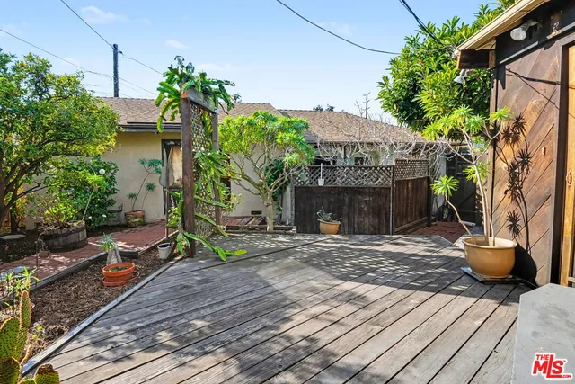 a view of a house with potted plants