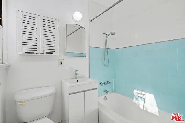 a bathroom with a sink a toilet and bathtub