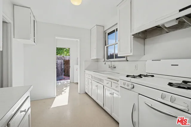 a kitchen with stainless steel appliances a sink stove and cabinets