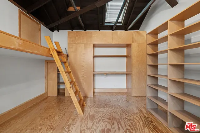 a view of walk in closet with empty racks