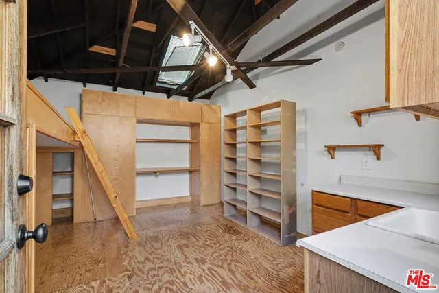 a view of walk in closet with empty racks